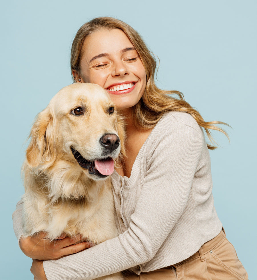 Woman hugging a golden retriever